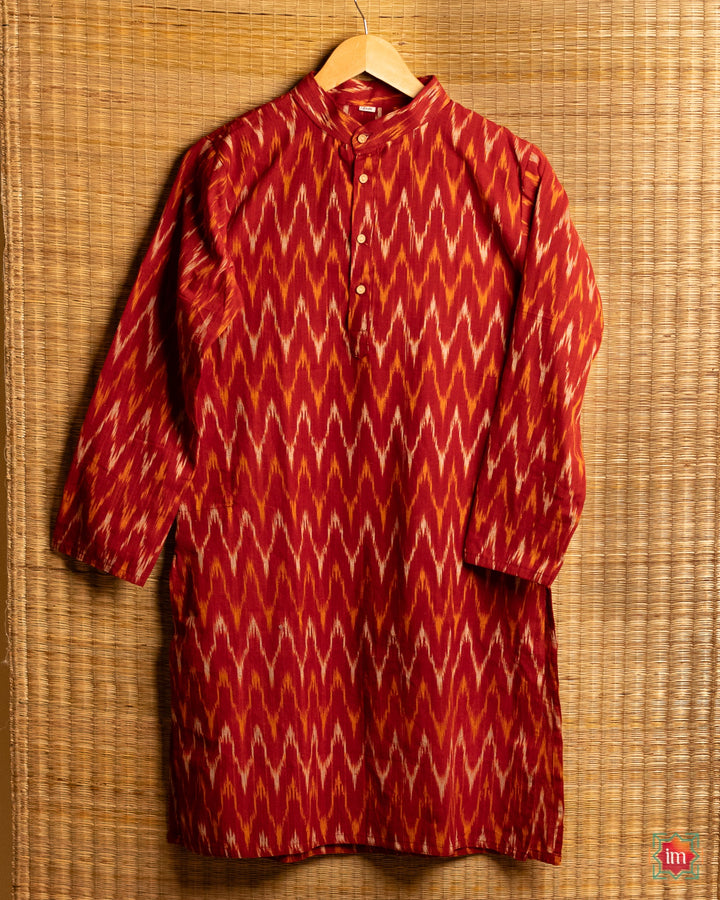 Unisex maroon kids kurta hanged on a hanger with mat in the background.