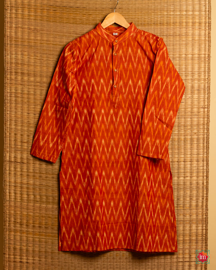 Unisex orange kids kurta hanged on a hanger.