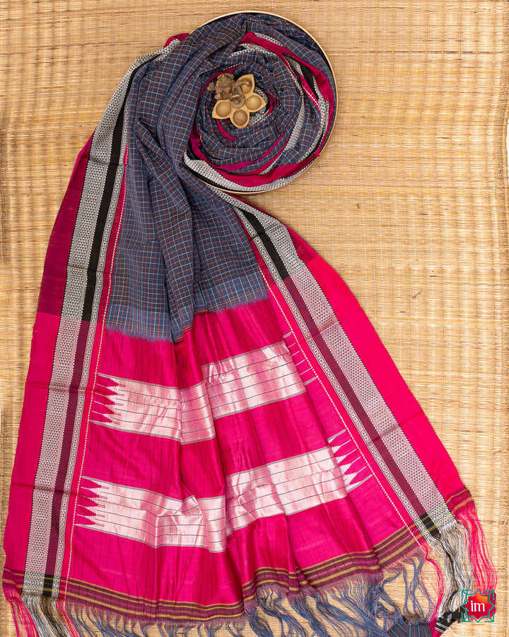 Beautiful blue handloom cotton saree kept on a plate with ganapati statue upon the saree which are kept upon the mat.