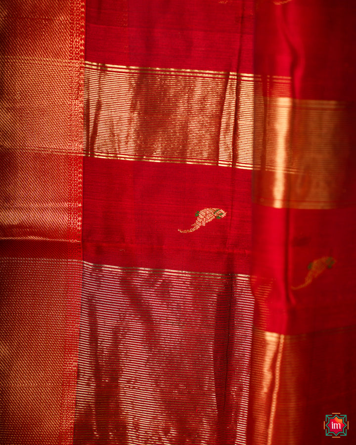 Elegant red hadloom cotton saree, where in the detailed saree print is displayed.