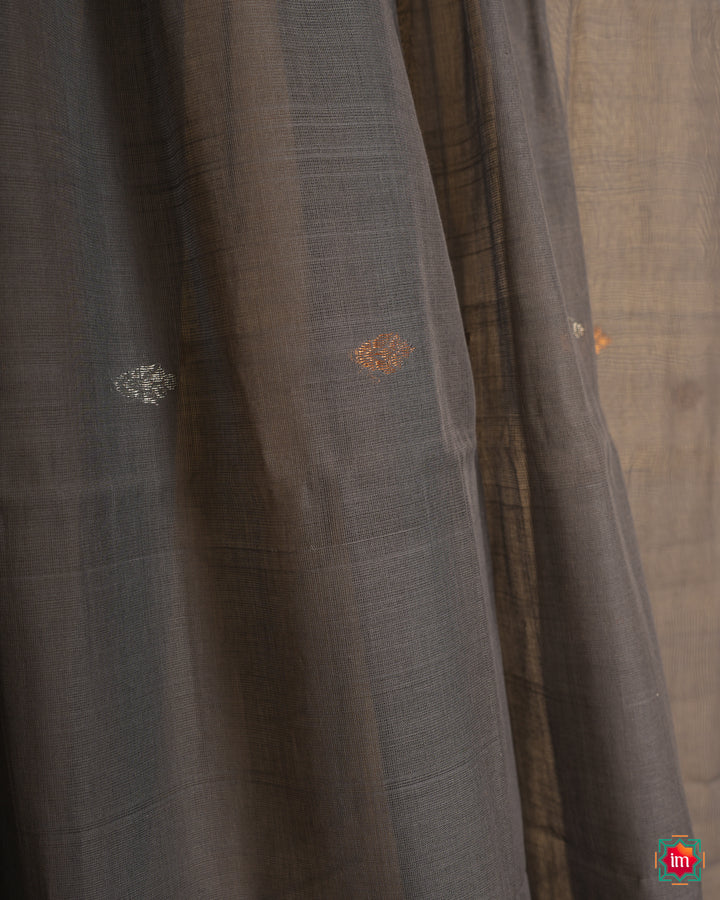 Grey handloom cotton saree, where in the detailed saree print is displayed.